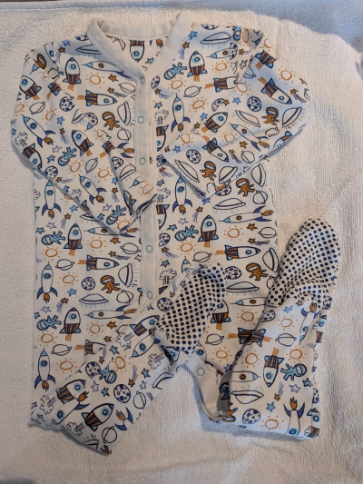Space pattern baby sleepsuit by Mothercare — pre-loved on Thrifted.mt