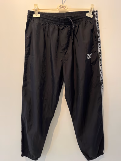 Black Taped Tracksuit Bottoms by ÀLG — pre-loved on Thrifted.mt