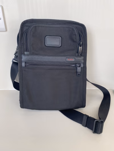 Tumi Alpha Black Crossbody Travel Bag by Tumi — pre-loved on Thrifted.mt
