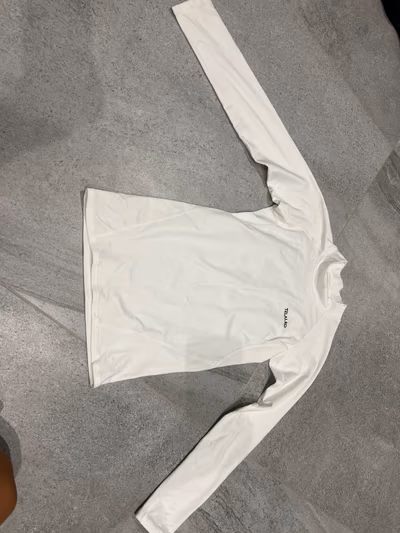 White long sleeve base layer by Telaleo — pre-loved on Thrifted.mt